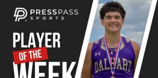 Athlete in a purple high school jersey with medals smiles on a 'Player of the Week' poster fronted by bold text and graphics.